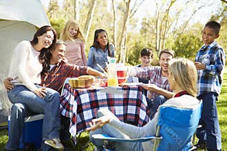 Two Families Enjoying Camping Holiday In Countryside