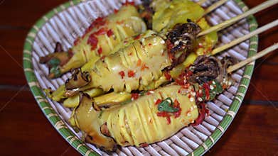 Grilled Squid on Charcoal Stove with Spicy Seafood Sauce in 4K