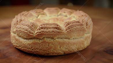 Close Up of Golden Brown Bu?uelo on Wooden Table Showcasing Its Intricate Circular Shape and Delicate Patterns Suitable For Bakery