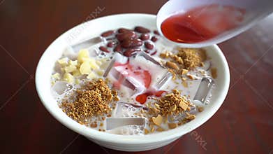 Delicious Ais Kacang Dessert Displayed on Wooden Table with Red Beans Jelly and Corn Refreshing Malaysian Cuisine Perfect for