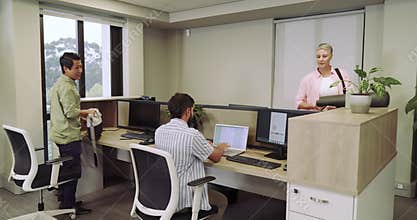 Diverse coworkers unpacking messenger bag and placing yoga mat at office high-fiving near bicycle