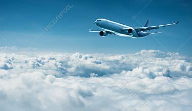 Airplane flies above clouds - air travel