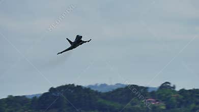 Jet fighter in dynamic roll during flight show