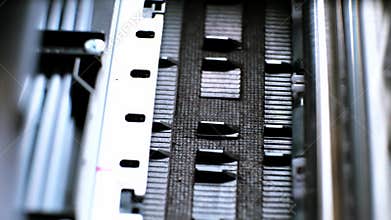 The process of printing a color inkjet printer in close-up. The rolles is rolling inside of device and printed a picture