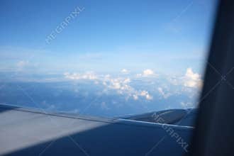 Serene Aerial View of Fluffy Clouds from Airplane Window Focus on Background