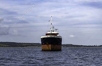 The general cargo ship \"Fri Brevik\" anchored just outside Penzance harbour in Cornwall