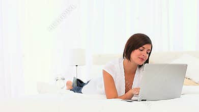Brunette enjoying a chat on her laptop