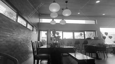 ideo of a stylish dining room with a large table inside a modern concrete house.