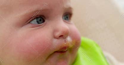 Adorable baby eating puree: a messy yet delightful mealtime