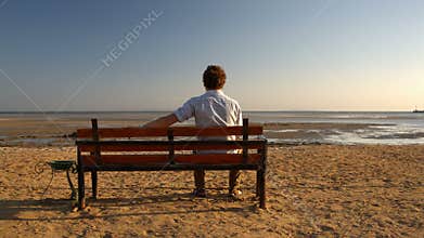 Man sitting alone on the beach