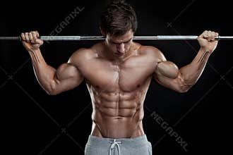 Muscular bodybuilder guy doing exercises with dumbbell