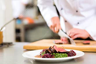 Chef in restaurant kitchen preparing food
