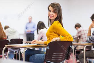 Female with blurred teachers students in classroom