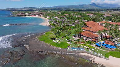 Aerial View of Poipu Beach Coastline with Resorts and Palm Trees