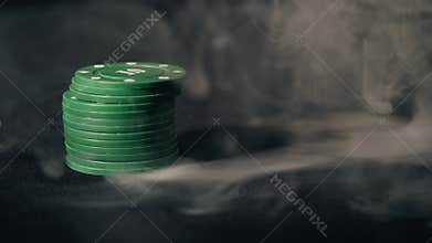 Poker chips on black smoke background