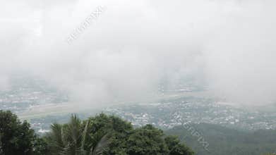 view of the local city of chiangmai from mountain hill under the cloud and fog level