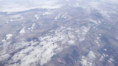 Aerial view of farmland fields forming a patchwork landscape under a serene sky. Peaceful horizon,
