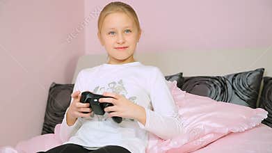 Girl playing video console game and win