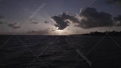 Drone shot where during the dawn people on the boats are swimming in a calm sea at Praia Da Baleia.