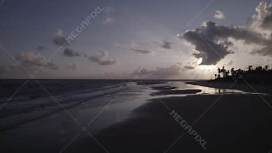 Group of people with their boats during the dawn at Praia Da Baleia, Itapipoca - CE, Brazil.
