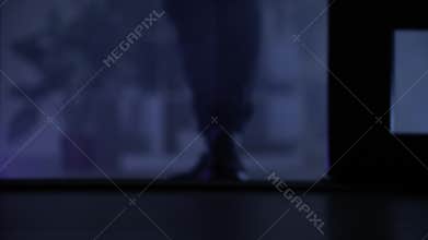 trespassing, male person opens door and enters premises at night, close-up of legs