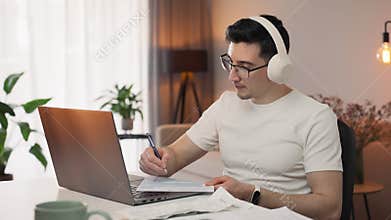 Taking charge of his finances, a man fills out his annual taxes with the help of an online adviser. Focused and