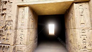 Ancient Egyptian hieroglyphics carved on sandstone walls framing a doorway with light shining through the entrance