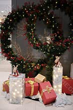 Chrismast decoration details with green leafy plants, gift boxes, owl and reindeer toy