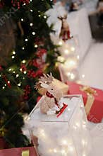 Chrismast decoration details with green leafy plants, gift boxes and reindeer toy