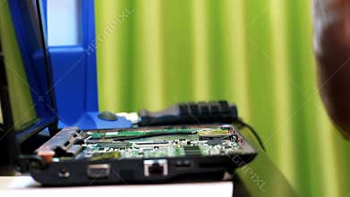 Repairman assembling laptop computer