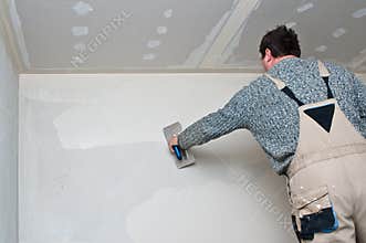Plasterer or dry waller at work