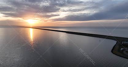 Aerial view of the Afsluitdijk Bridge, at sunset in Breezanddijk city, Netherlands