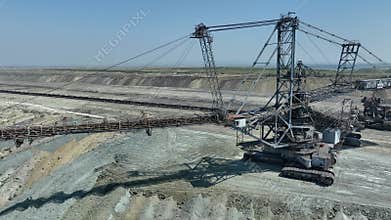 Top shot of a large bucket-wheel excavator in a lignite (brown-coal) mine. ?erial view. Coal transshipment.