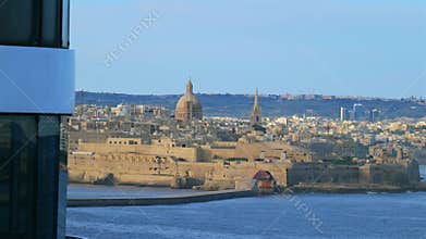 Lighthouse and fortifications of Valletta, Malta, with St. Paul's Cathedral in view