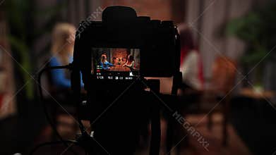 Two Influencers of women being interviewed in a loft-style podcast studio