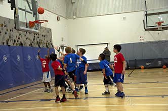 Kids playing basketball match
