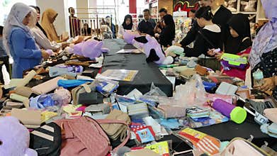 People Shopping at a Bazaar Booth with Various Products Displayed