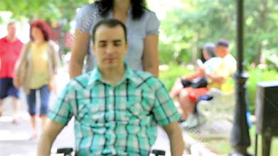 Young man in wheelchair in the city park