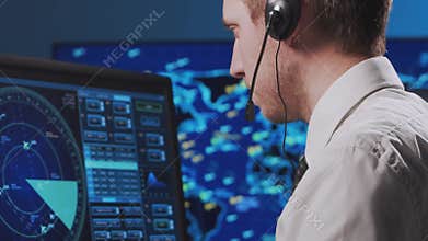 Professional air traffic controller in the control tower. Aircraft control officer works using radar, computer navigation and