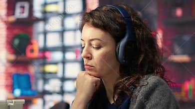 Female videographer working with dual monitors at the creative agency