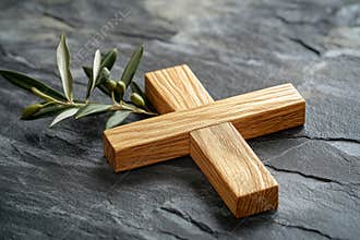A textured background provides the setting for a wooden cross paired with an olive branch, suitable for religious themes