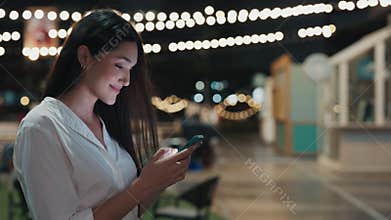 Owner Of Night Cafe, Young Woman, Standing near Restaurant And Chats On Smartphone Outside.