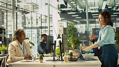 Accountant in busy modern startup agency imputing financial figures on PC