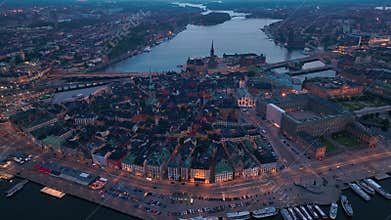 Aerial view of Stockholm old town. Night flying over the bay. Drone twilight footage of Stockholm