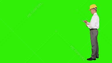 Young architect taking notes on a clipboard