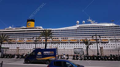 Cruise ship docked in Cadiz, Spain, with scooters parked in the foreground - CADIZ, SPAIN - MARCH 26, 2025