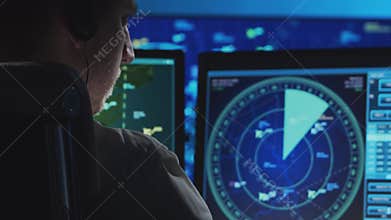 Professional air traffic controller in the control tower. Aircraft control officer works using radar, computer