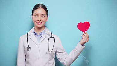Female doctor cardiologist showing heart symbol