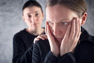 Comforting friend. Woman consoling her sad friend.