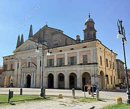 Historic church with a classic facade and bell tower in Gualtieri, Italy.